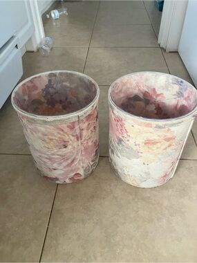 2 vintage floral tapestry fabric wastebaskets with plastic liners in them